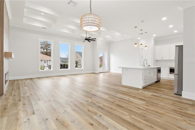 unfurnished living room with ceiling fan, sink, coffered ceiling, light hardwood / wood-style flooring, and ornamental molding