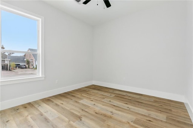 unfurnished room featuring light hardwood / wood-style floors, plenty of natural light, and ceiling fan