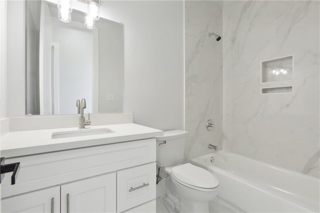 full bathroom featuring tiled shower / bath combo, toilet, and vanity