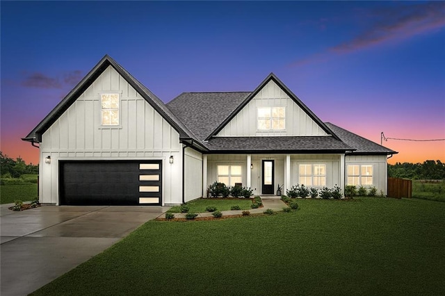 modern farmhouse featuring a garage and a lawn