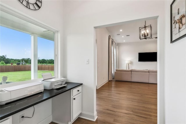 interior space featuring dark hardwood / wood-style floors and a chandelier