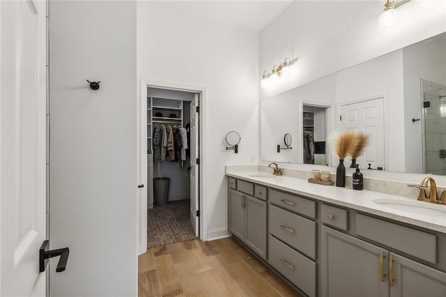 bathroom with vanity, an enclosed shower, and hardwood / wood-style floors