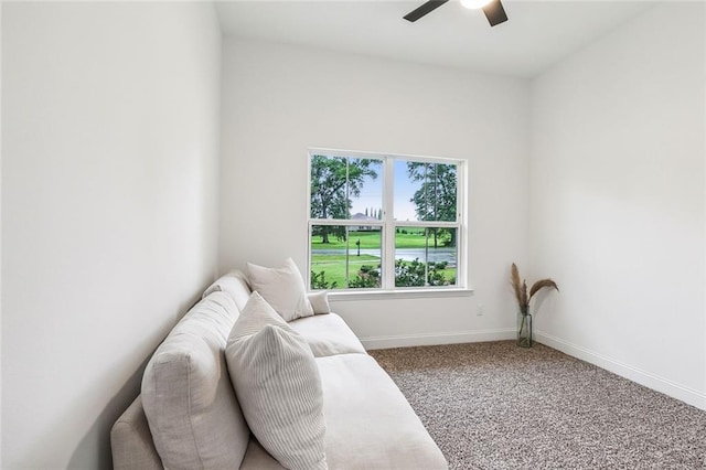 sitting room featuring ceiling fan and carpet