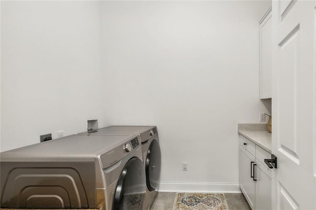 washroom with cabinets, light tile patterned floors, and independent washer and dryer