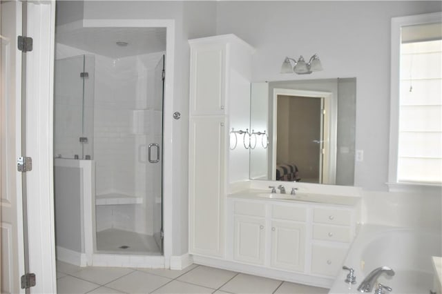 bathroom with tile patterned floors, vanity, and independent shower and bath