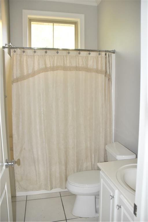 bathroom with tile patterned flooring, vanity, and toilet