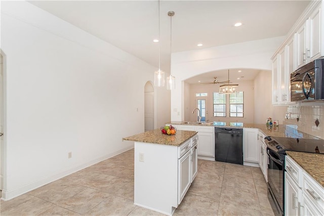 kitchen with a center island, hanging light fixtures, kitchen peninsula, white cabinets, and black appliances