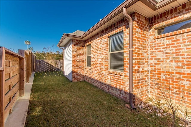 view of side of home with a lawn