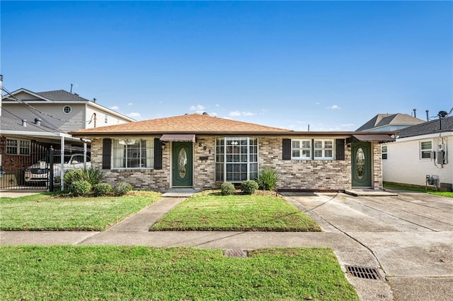 view of front of house with a carport and a front lawn