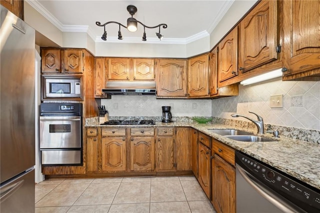 kitchen with crown molding, sink, light stone counters, and appliances with stainless steel finishes