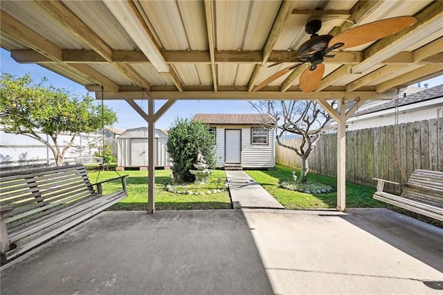 view of patio with a storage unit and ceiling fan