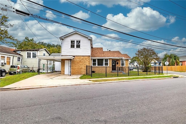2501 Sage St, New Orleans, LA 70122 - view of front facade with concrete driveway, a fenced front yard, and brick siding