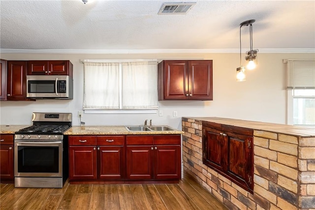 2501 Sage St, New Orleans, LA 70122 - kitchen with a sink, reddish brown cabinets, stainless steel appliances, visible vents, and ornamental molding