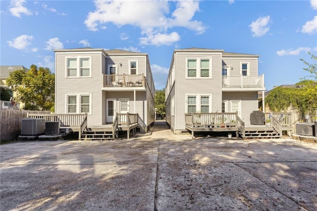 back of house featuring a wooden deck and central AC