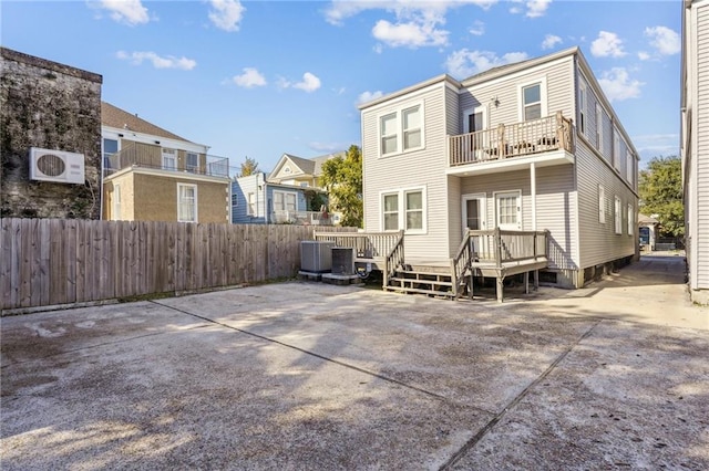 back of property featuring a wooden deck