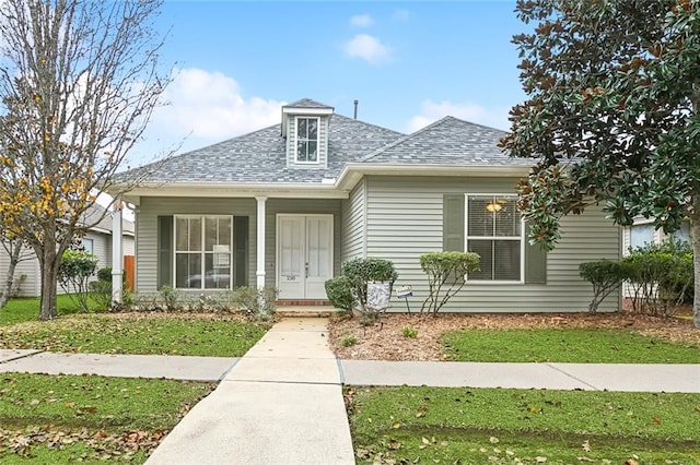 bungalow-style home with a front yard