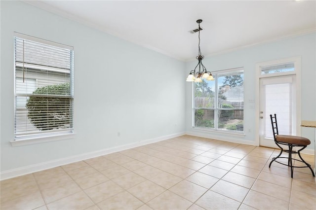 unfurnished dining area with light tile patterned floors, a chandelier, and ornamental molding