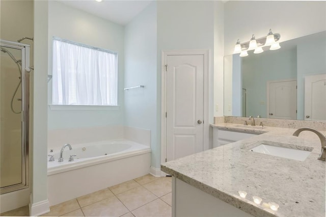 bathroom with tile patterned floors, vanity, and shower with separate bathtub