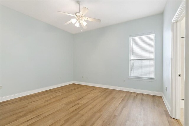 spare room featuring light hardwood / wood-style floors and ceiling fan