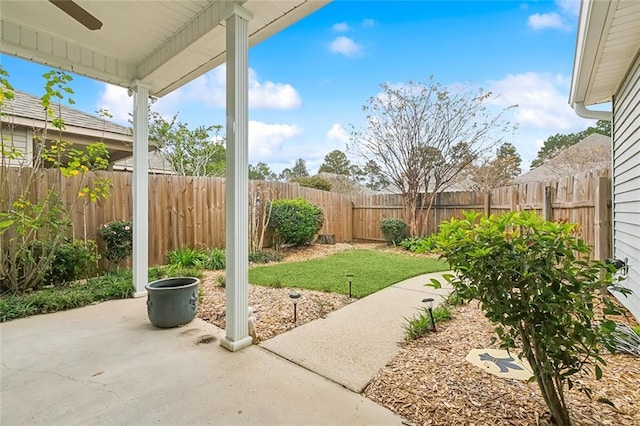 view of yard with ceiling fan and a patio