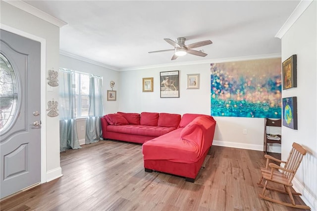 living room featuring hardwood / wood-style flooring, ceiling fan, and ornamental molding