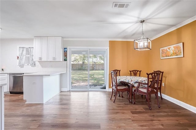 dining area featuring hardwood / wood-style flooring and crown molding