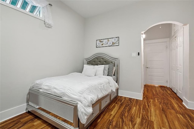 bedroom with dark wood-type flooring