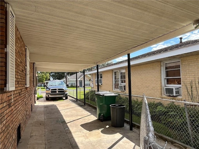 view of patio / terrace with cooling unit and a carport