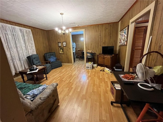 sitting room with a chandelier, wood walls, and light hardwood / wood-style flooring