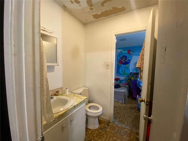 bathroom featuring vanity and toilet