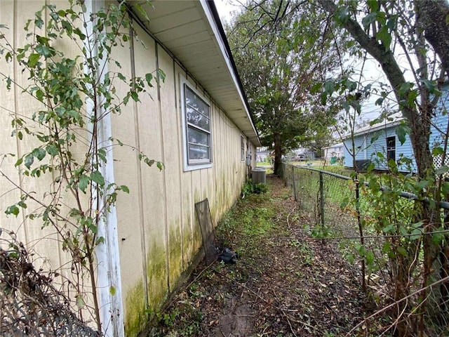 view of side of home featuring central AC