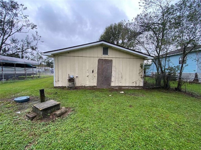 rear view of house with an outbuilding and a yard