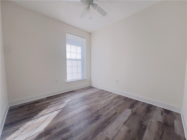 spare room featuring ceiling fan and dark hardwood / wood-style floors