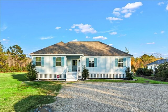 view of front of house with covered porch and a front lawn