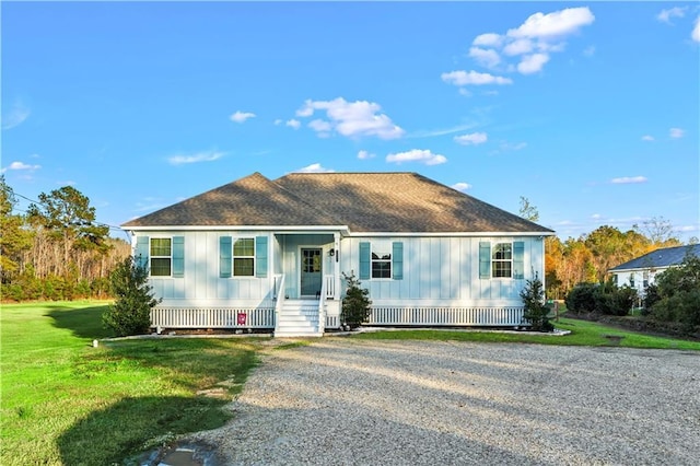 view of front of house featuring covered porch and a front lawn