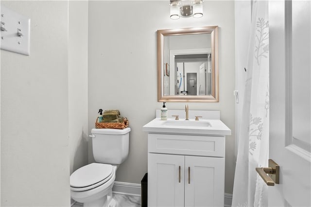 bathroom featuring vanity and toilet