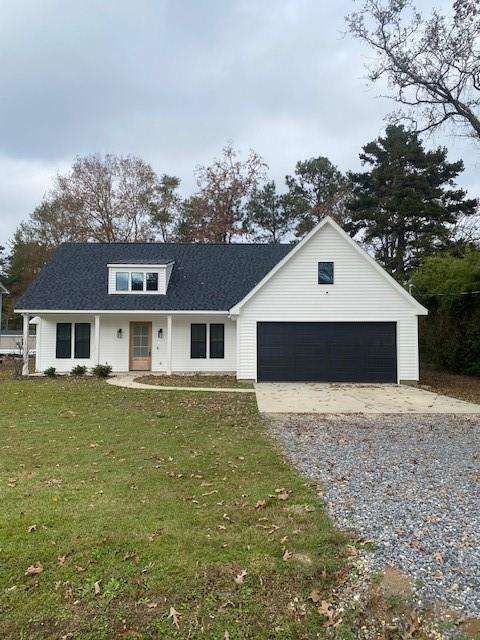 view of front of property with a front yard and a garage