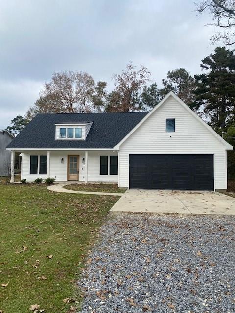 view of front of property featuring a front lawn and a garage