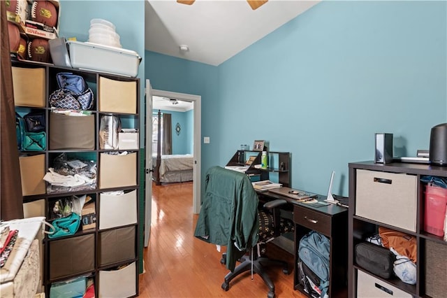 home office with wood finished floors and a ceiling fan