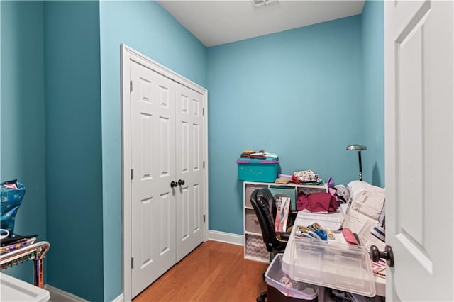home office with wood finished floors and baseboards