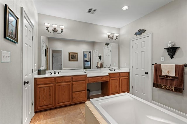 bathroom with tile patterned flooring, double vanity, visible vents, a sink, and a bathing tub