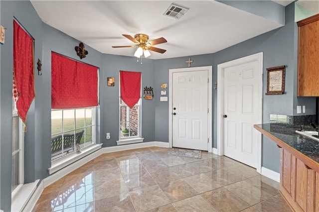 foyer entrance with ceiling fan