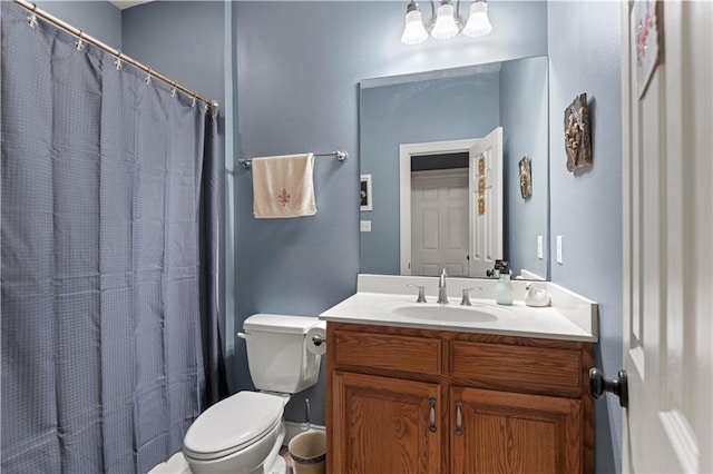 bathroom featuring toilet, vanity, and a shower with shower curtain