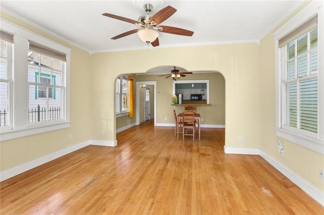 interior space featuring light hardwood / wood-style floors, ceiling fan, and ornamental molding