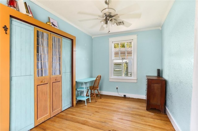 interior space with crown molding, light hardwood / wood-style flooring, and ceiling fan