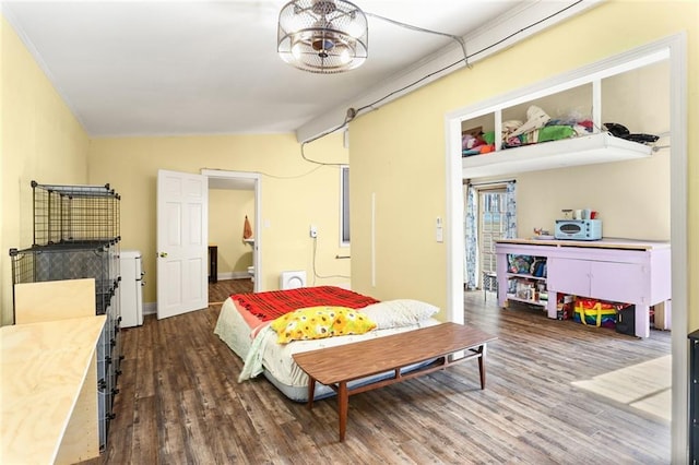 bedroom featuring lofted ceiling and dark hardwood / wood-style floors