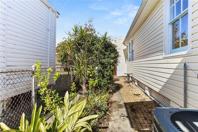 view of side of property featuring cooling unit and a patio area