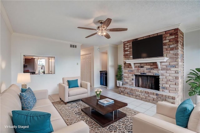 tiled living room featuring ceiling fan, ornamental molding, and a brick fireplace