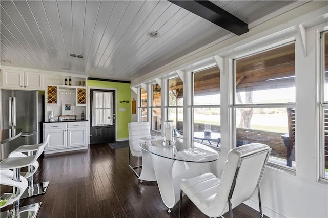 dining room with dark hardwood / wood-style floors and wood ceiling