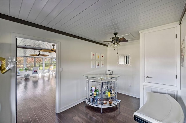 interior space featuring bar area, crown molding, dark wood-type flooring, and wooden ceiling